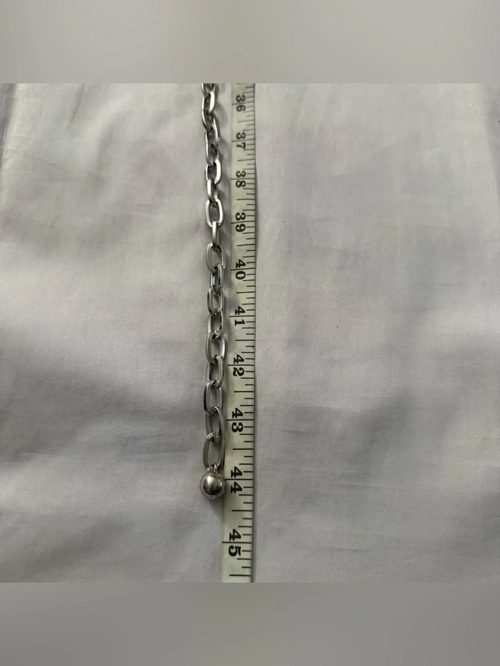 Silver tone metallic charms skinny chain belt